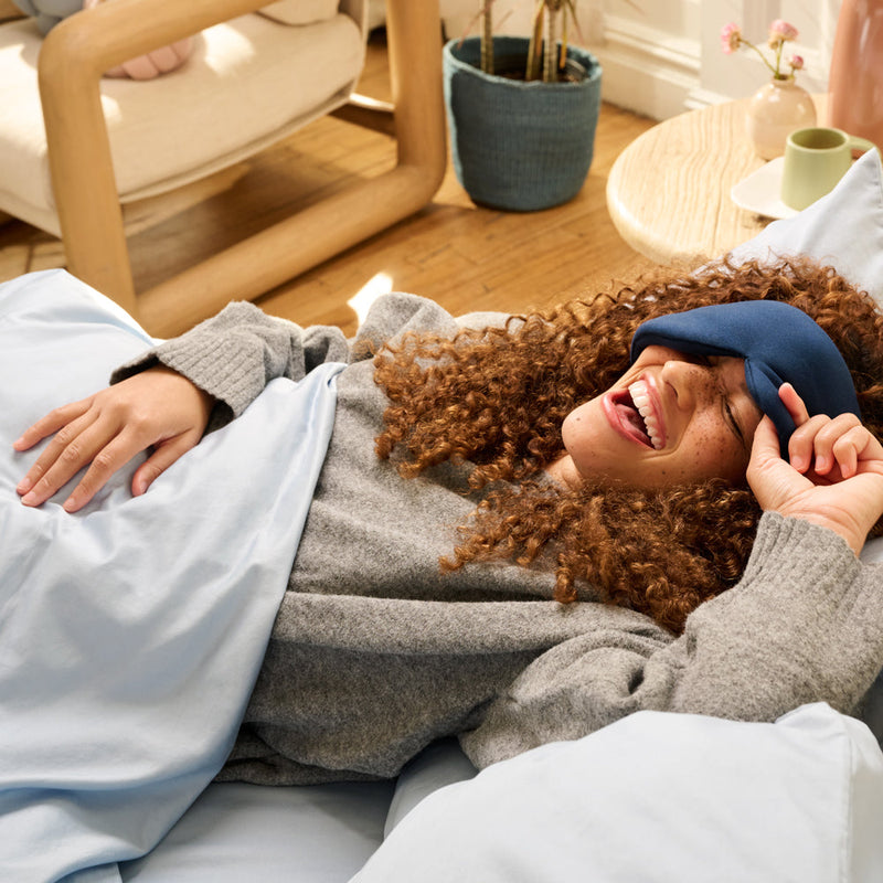 smiling lady with gently weighted sleep mask