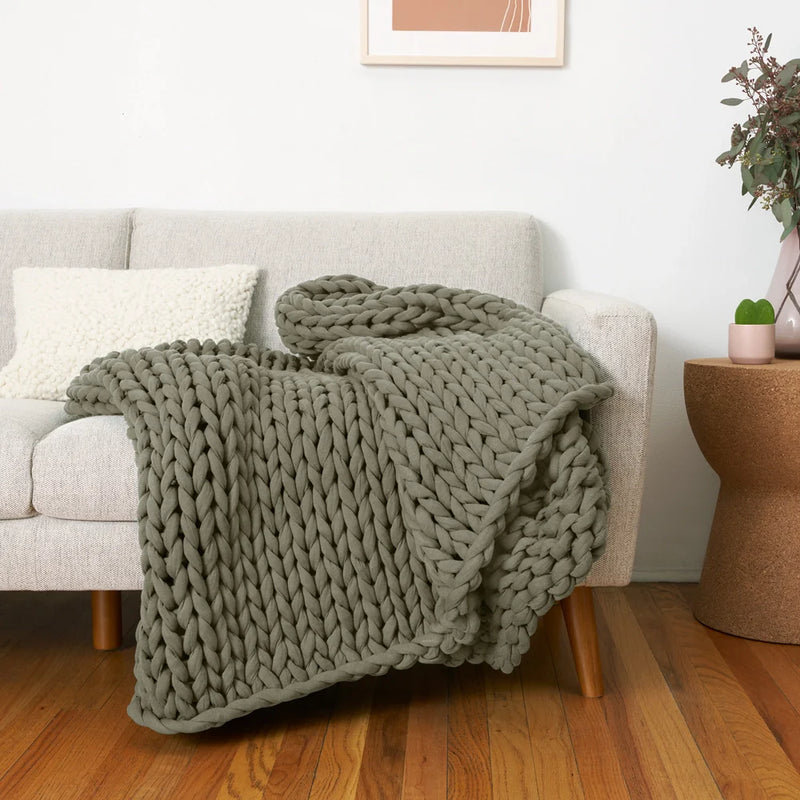 bearaby sage color weighted blanket on couch